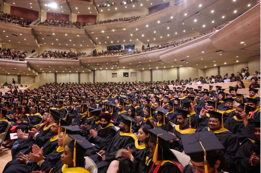 students graduating in a conference hall