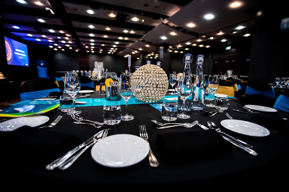 Futuristic corporate event theme using LED lighting, tech displays, and digital networking tools