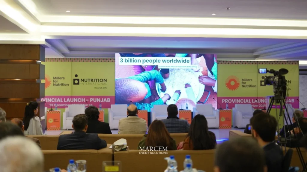 Corporate event management team coordinating registration desk and guest check-in at a business event